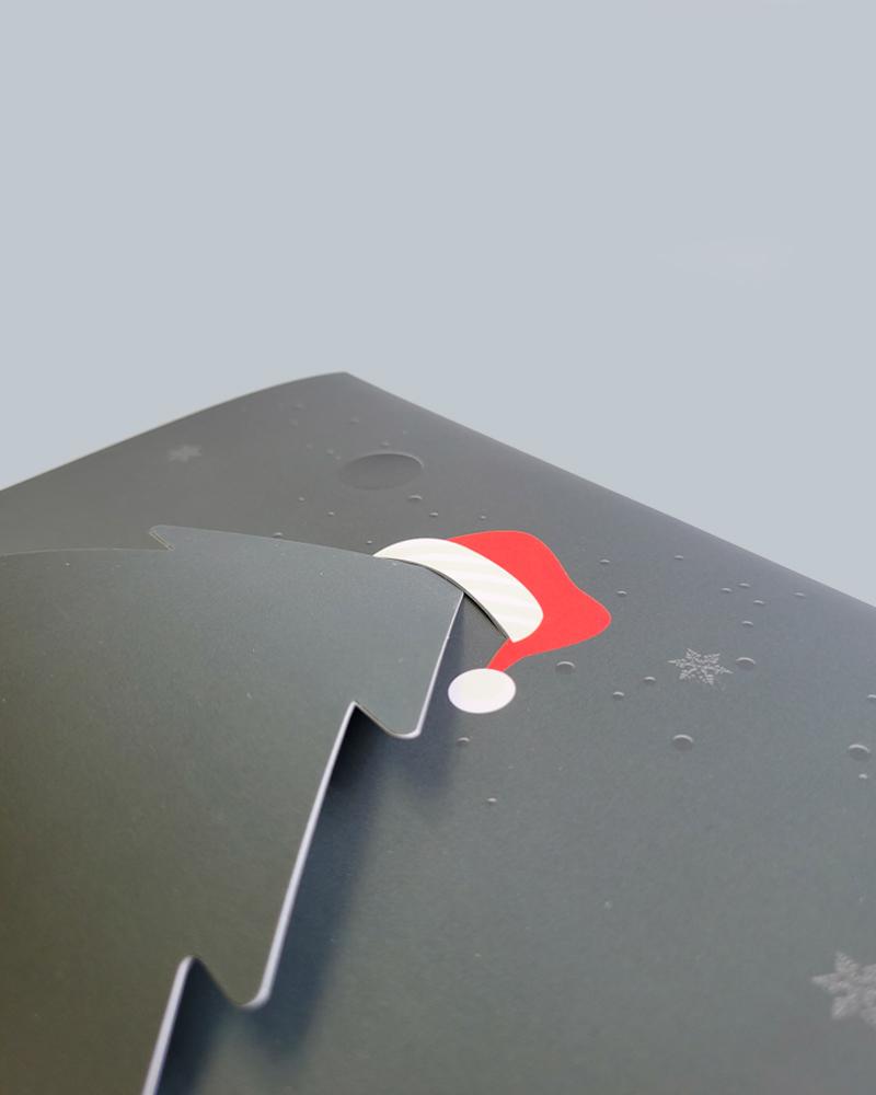 close up view of a Christmas tree with a Santa hat