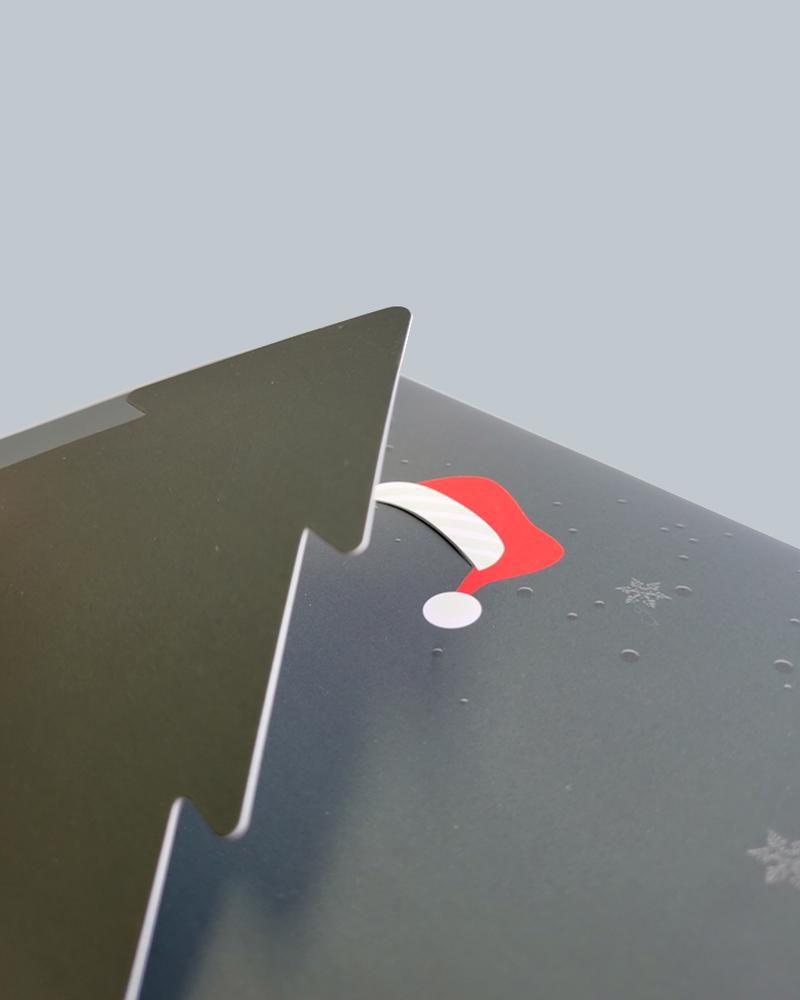 close up view of a Christmas tree with a Santa hat